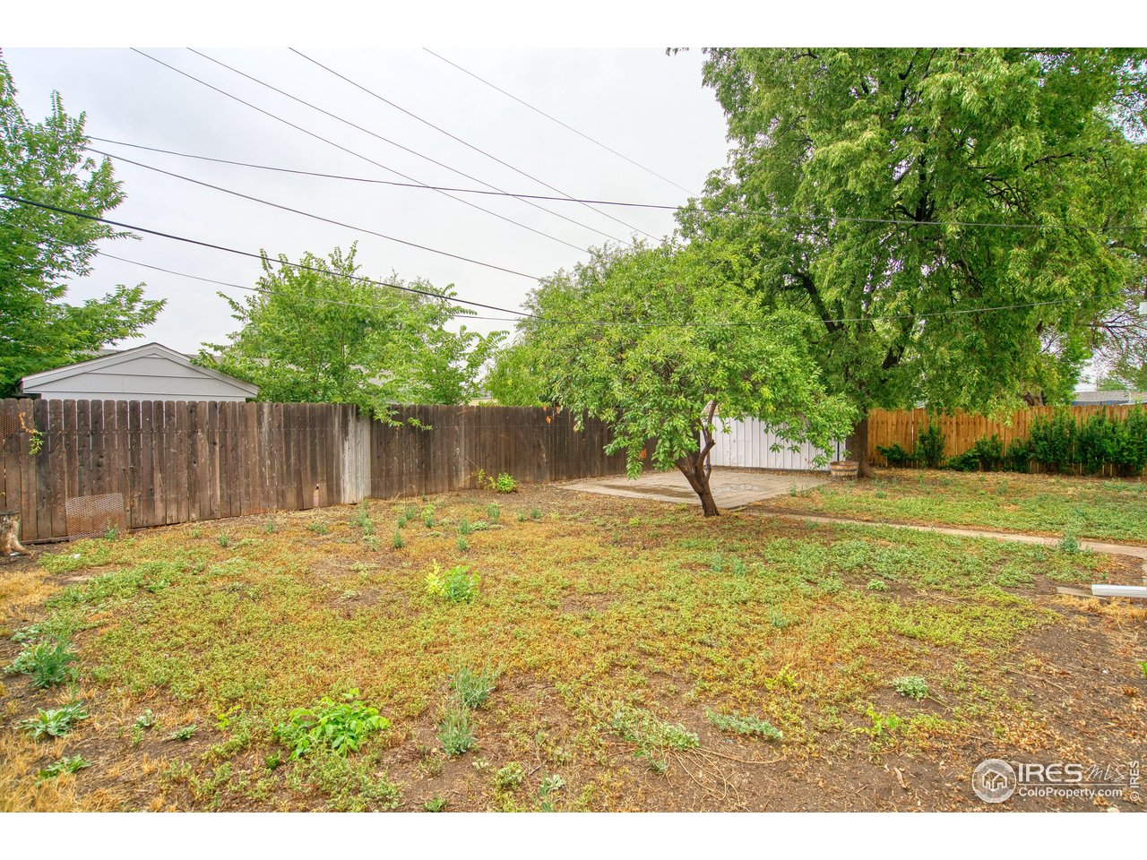361 Delaware Street Sterling, CO 80751 - Photo 24 of 27 a swimming pool with wooden fence
