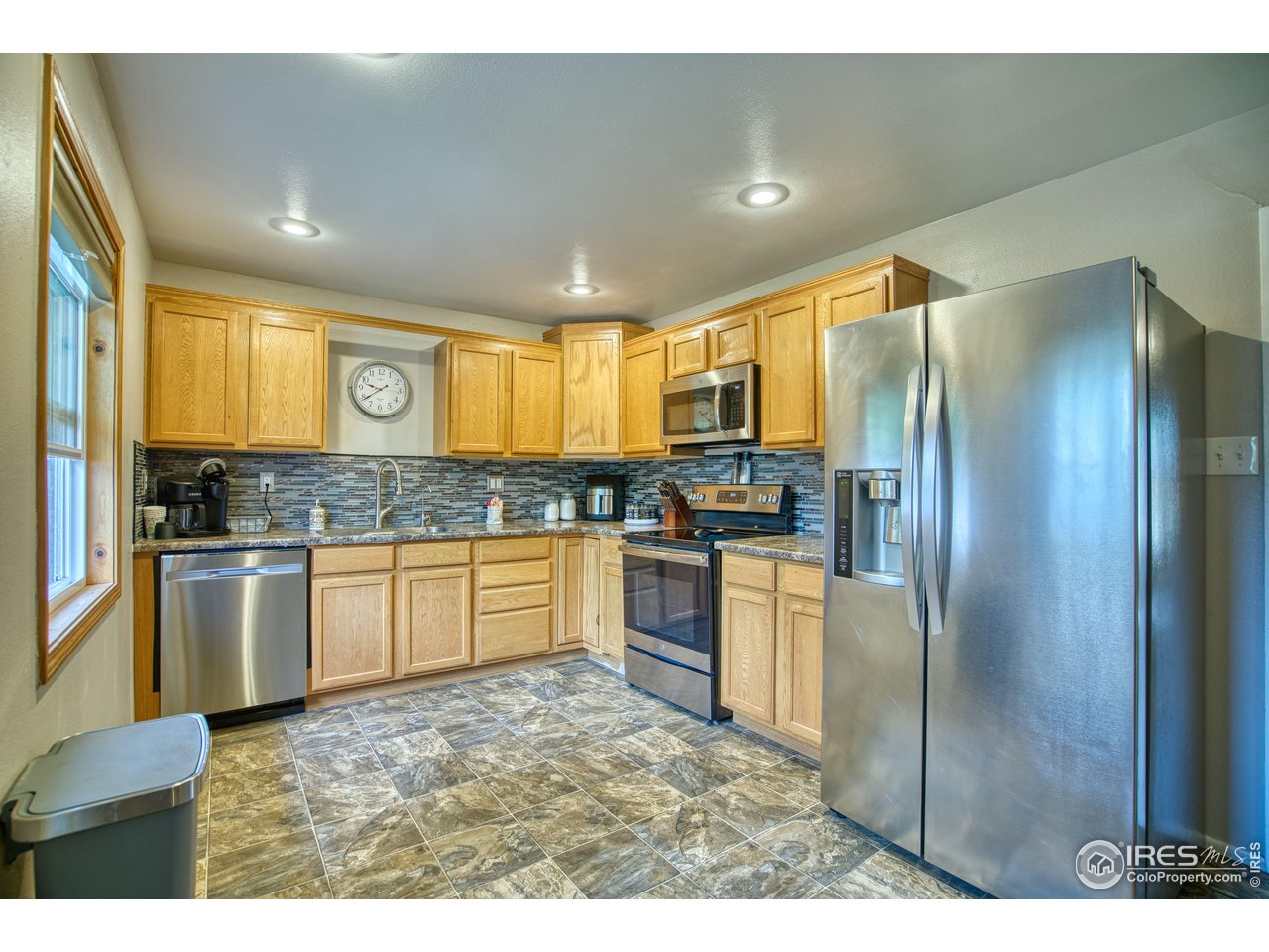 361 Delaware Street Sterling, CO 80751 - Photo 8 of 27 a kitchen with stainless steel appliances granite countertop a refrigerator and a stove top oven