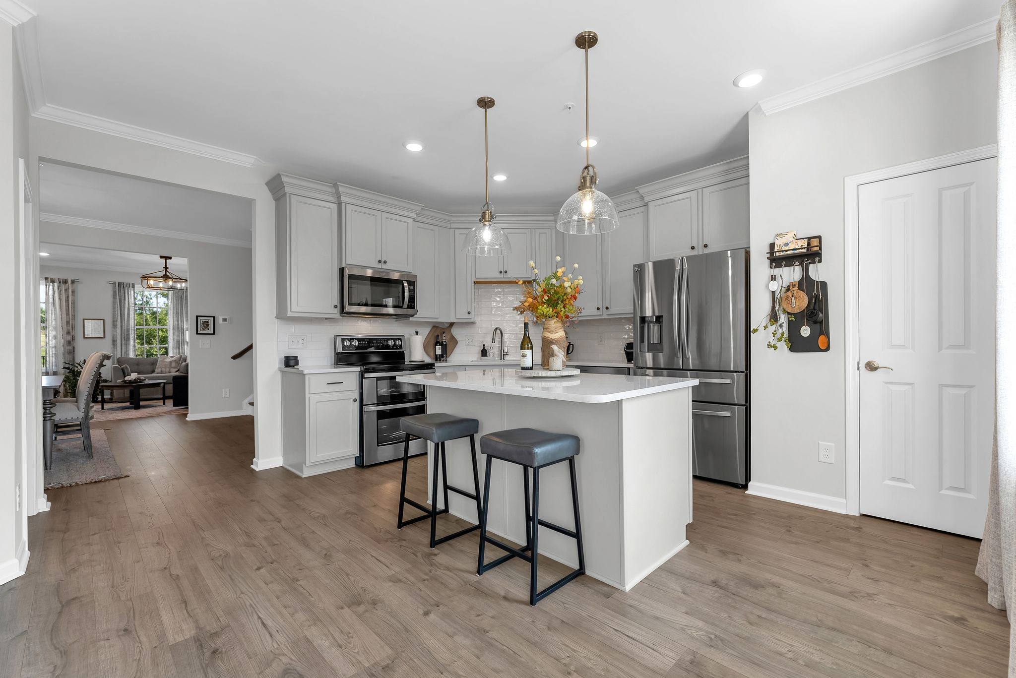 2083 Tollgate Boulevard Thompson's Station, TN 37179 - Photo 15 of 40 a kitchen with kitchen island white cabinets and stainless steel appliances