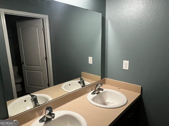 a bathroom with a sink vanity and a mirror