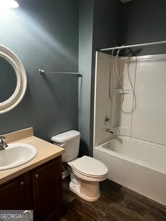 a bathroom with a toilet a sink and bathtub