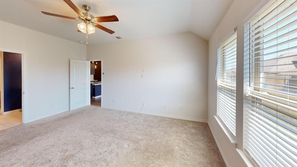 405 Rawhide Way Princeton, TX 75407 - Photo 11 of 22 an empty room with windows and fan