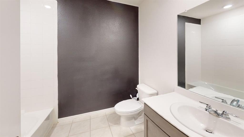 405 Rawhide Way Princeton, TX 75407 - Photo 15 of 22 a bathroom with a sink a toilet and a mirror