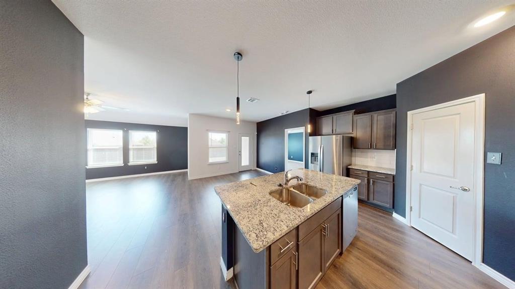 405 Rawhide Way Princeton, TX 75407 - Photo 22 of 22 a kitchen with a sink stove and refrigerator