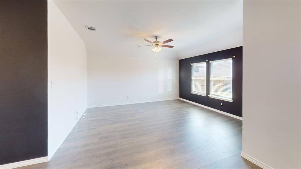 405 Rawhide Way Princeton, TX 75407 - Photo 8 of 22 wooden floor in an empty room with a window