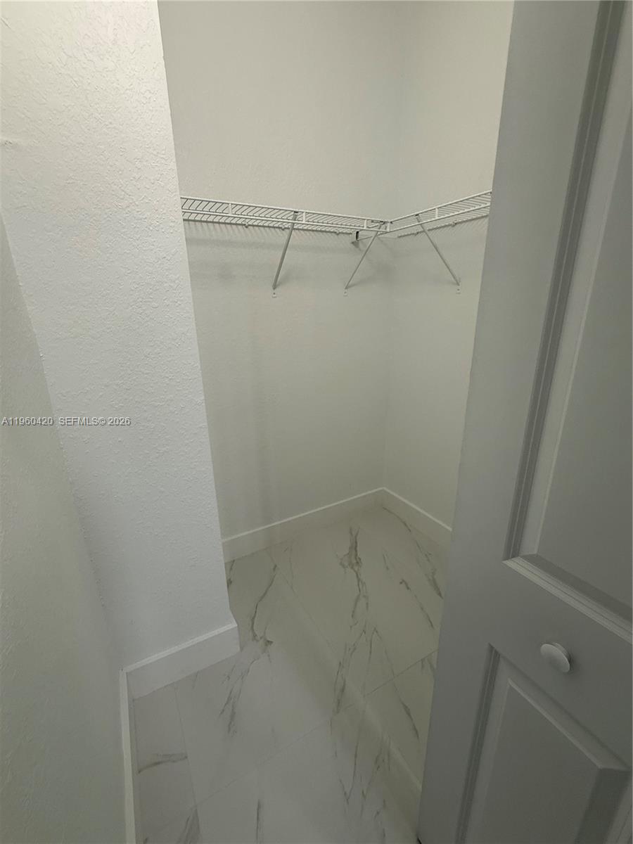 28519 Southwest 134th Court, Unit 28519 Homestead, FL 33033 - Photo 7 of 9 a view of a room with racks on the wall