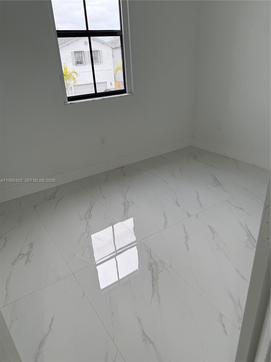 28519 Southwest 134th Court, Unit 28519 Homestead, FL 33033 - Photo 9 of 9 an empty room with windows