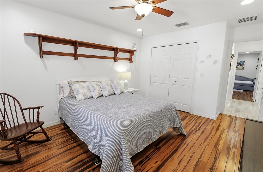 1771 Mistletoe Street Sebastian, FL 32958 - Photo 22 of 36 a bedroom with a bed and wooden floor