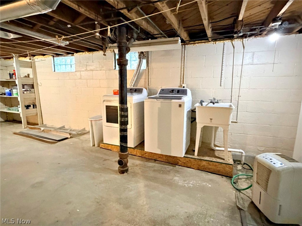 210 Callahan Road Canfield, OH 44406 - Photo 32 of 34 Basement laundry area featuring a utility sink and exposed ceiling joists