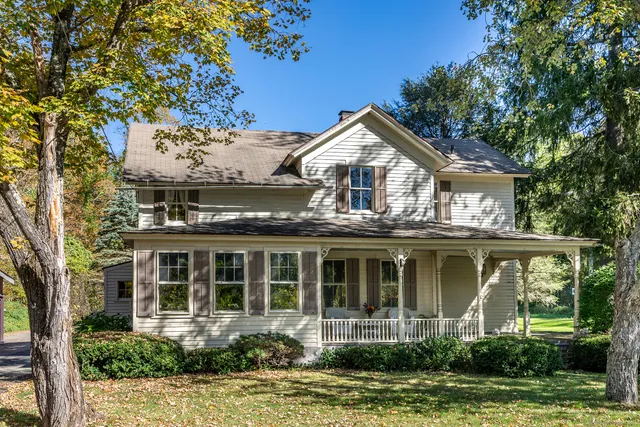 a front view of a house with a garden and plants