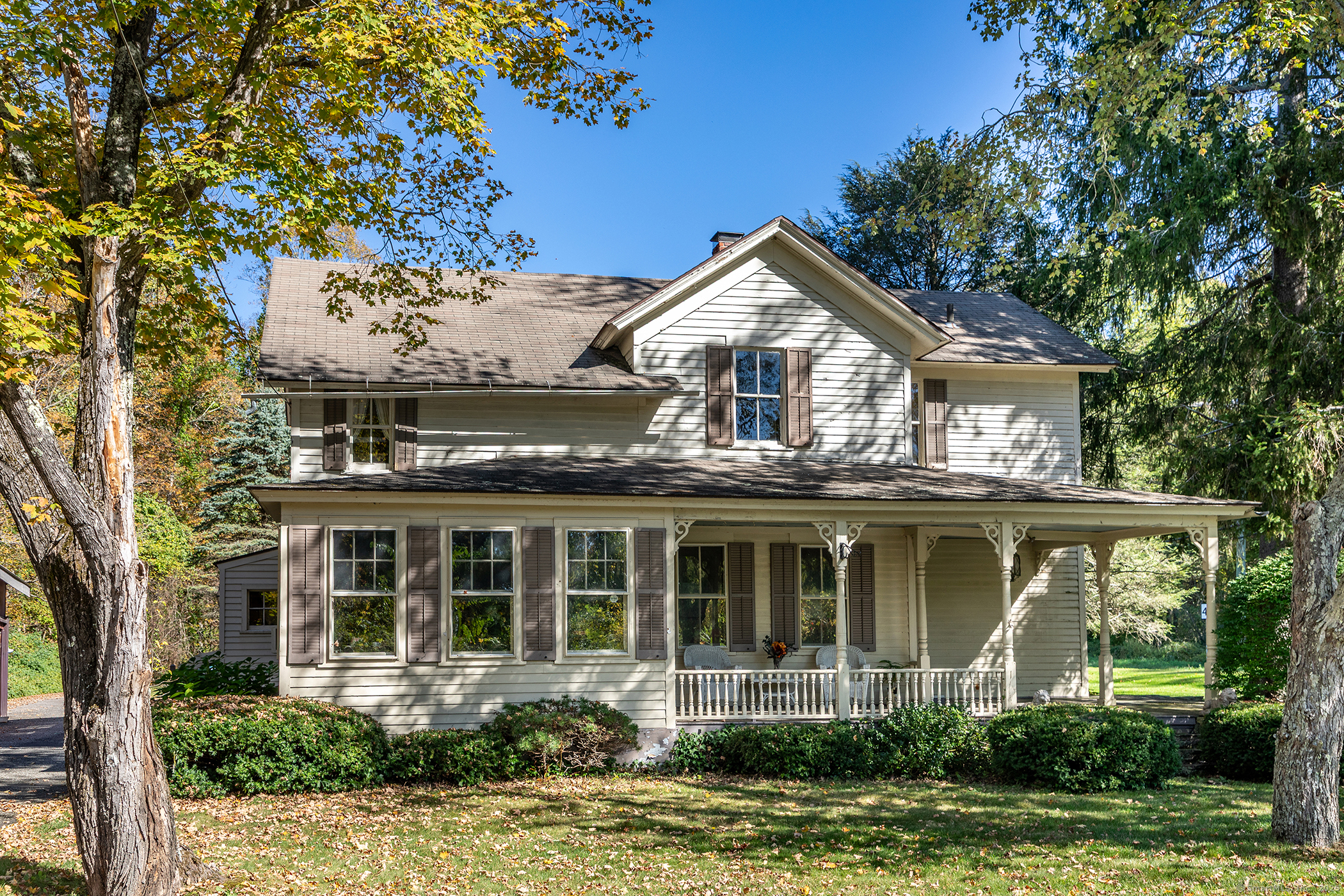 a front view of a house with a garden and plants
