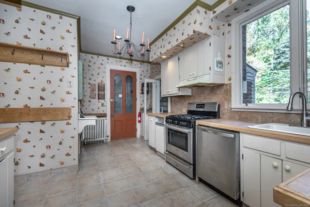 a kitchen with granite countertop a sink stove and window