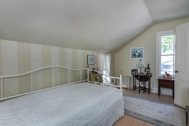 a bed room with a bed and a chair