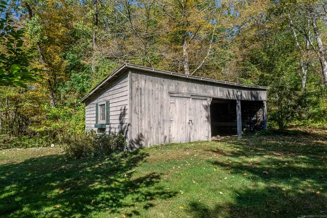 a house with green field in front of it
