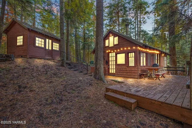 a view of wooden house with a yard in the background
