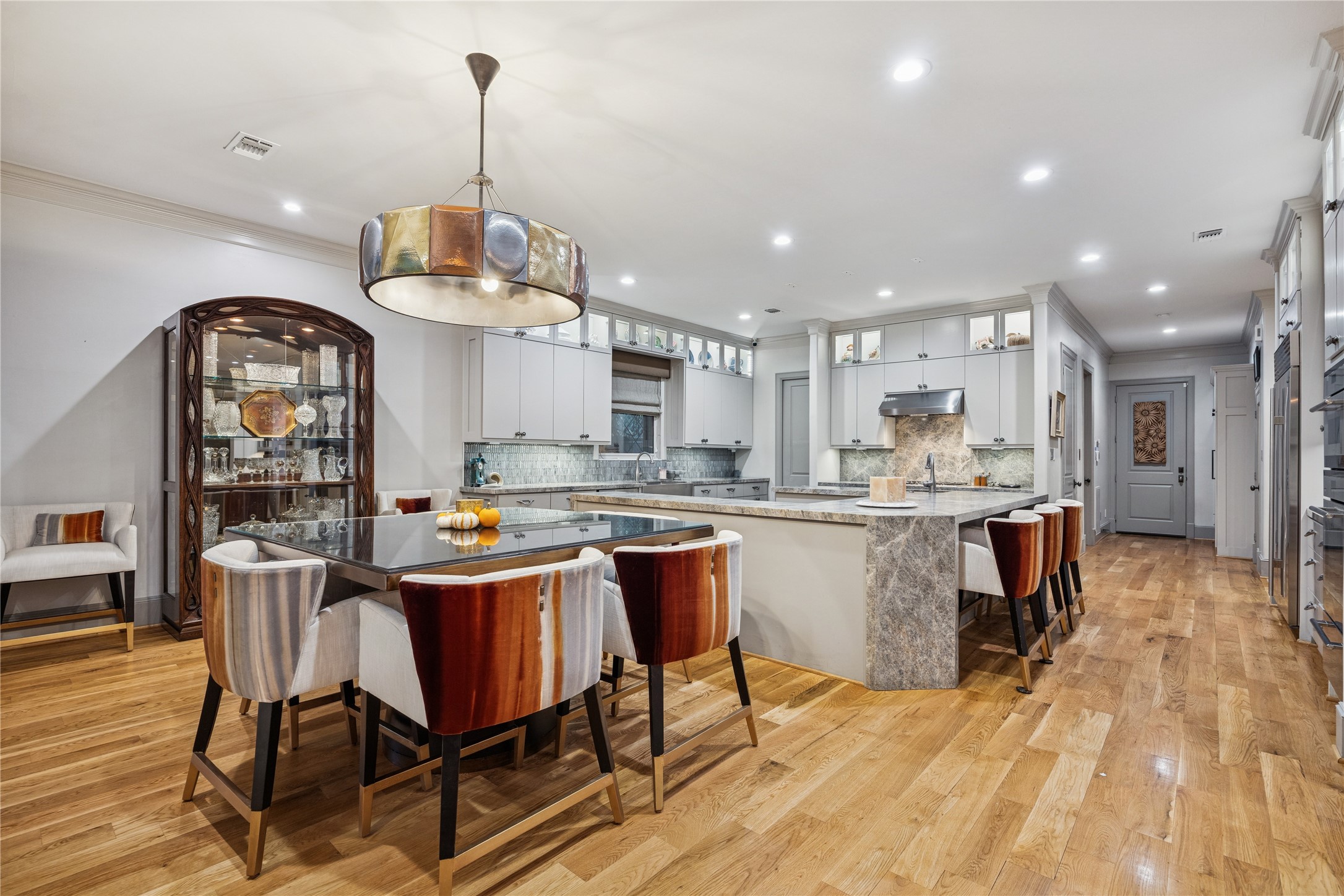 420 Pinewold Drive Houston, TX 77056 - Photo 33 of 41 a kitchen with a table chairs wooden floors and a view of living room