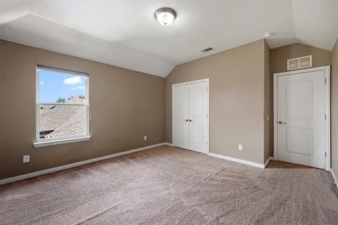 an empty room with windows and closet