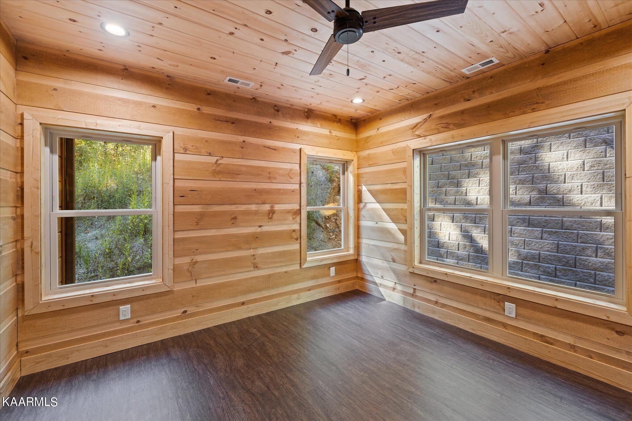 4228 Wears Valley Road, Unit 71 Sevierville, TN 37862 - Photo 12 of 28 a view of an empty room with a window and wooden floor