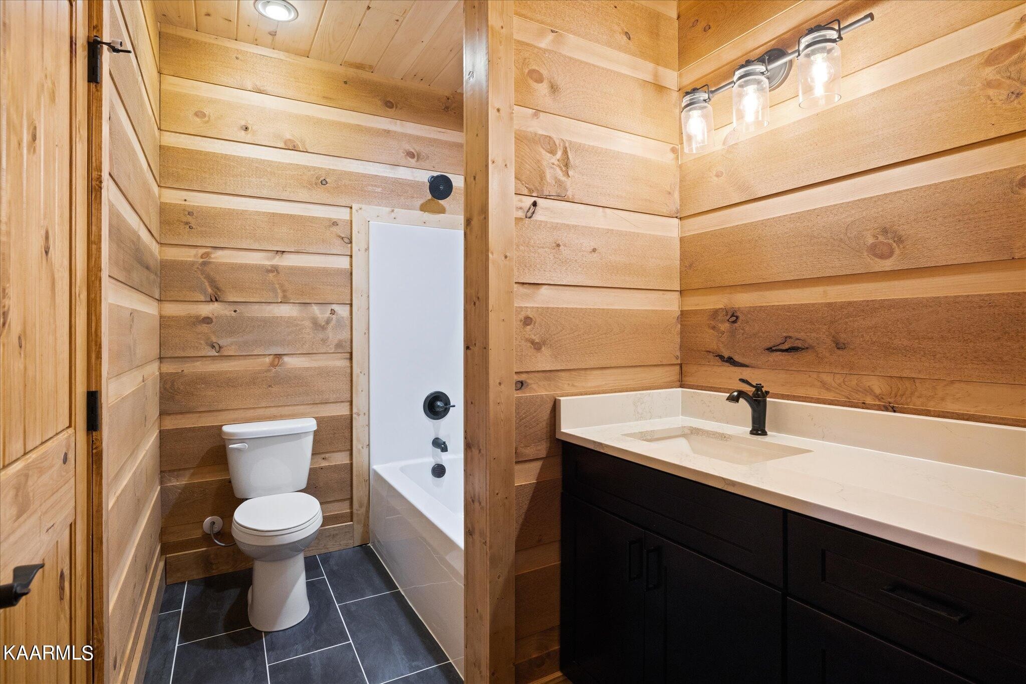 4228 Wears Valley Road, Unit 71 Sevierville, TN 37862 - Photo 14 of 28 a bathroom with a sink a toilet and shower
