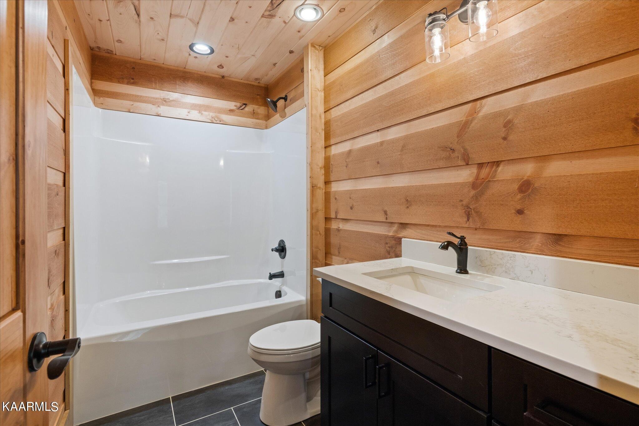 4228 Wears Valley Road, Unit 71 Sevierville, TN 37862 - Photo 25 of 28 a bathroom with a sink a toilet and shower