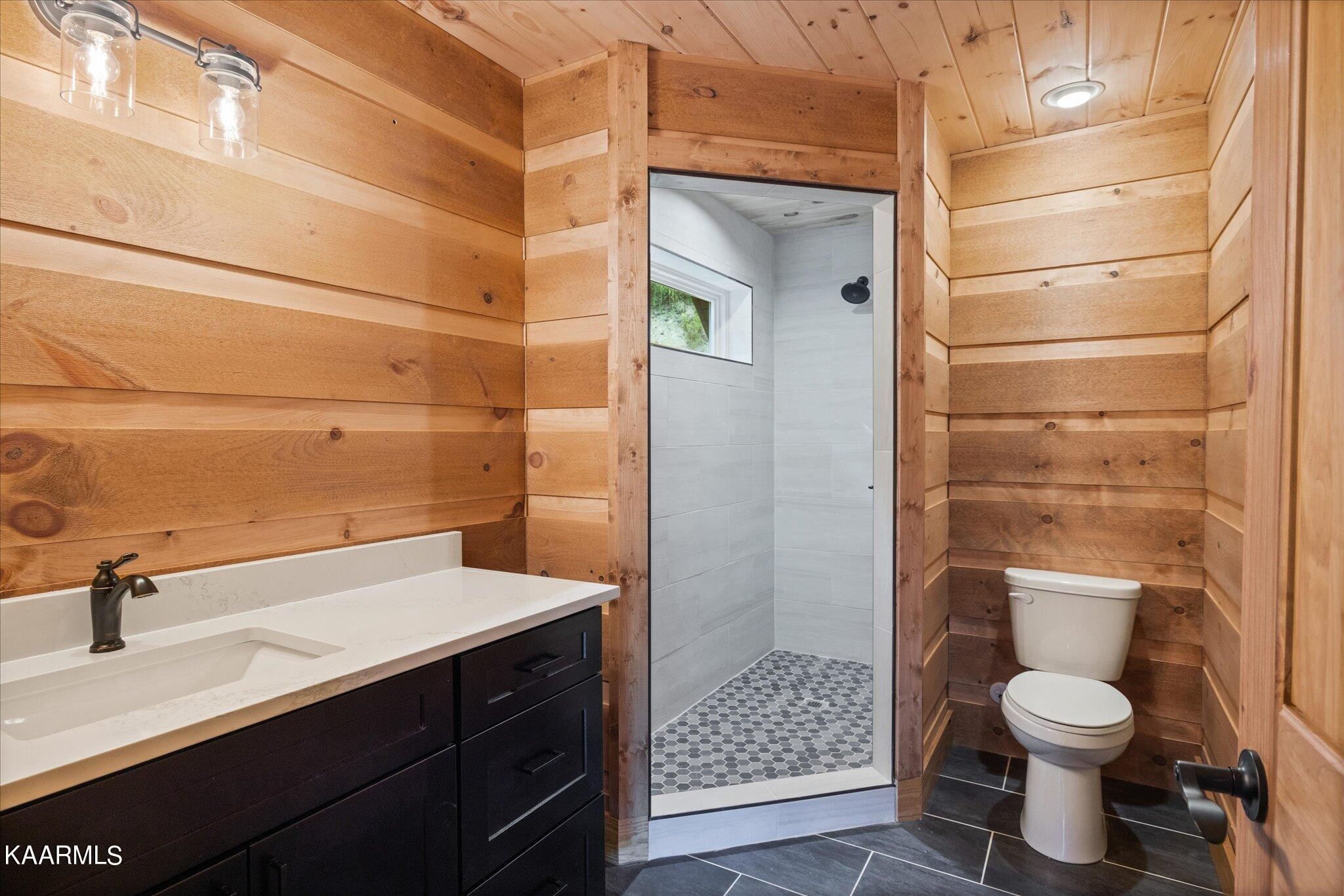 4228 Wears Valley Road, Unit 71 Sevierville, TN 37862 - Photo 28 of 28 a bathroom with a sink a toilet and shower