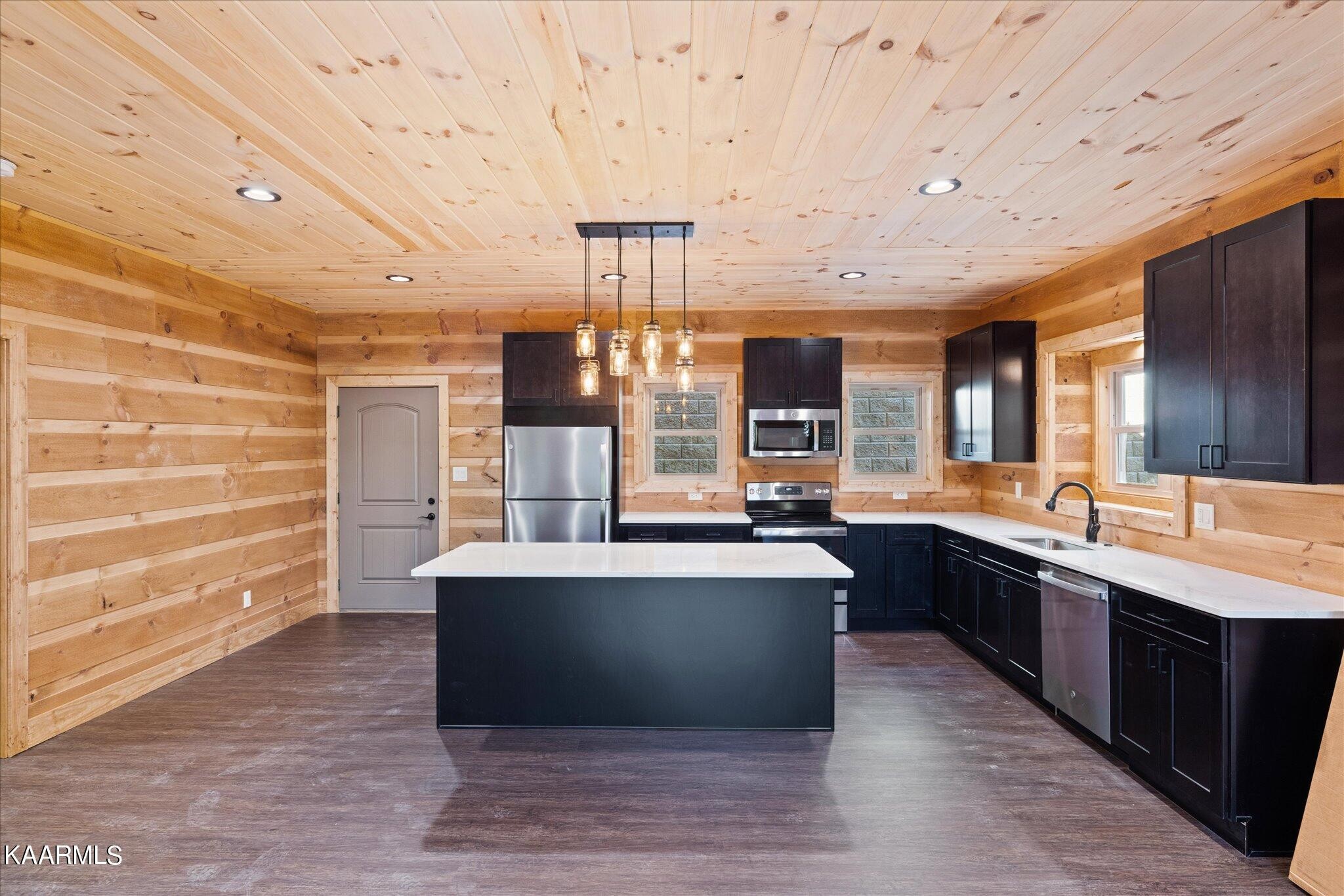 4228 Wears Valley Road, Unit 71 Sevierville, TN 37862 - Photo 7 of 28 a large kitchen with kitchen island a sink stainless steel appliances and cabinets