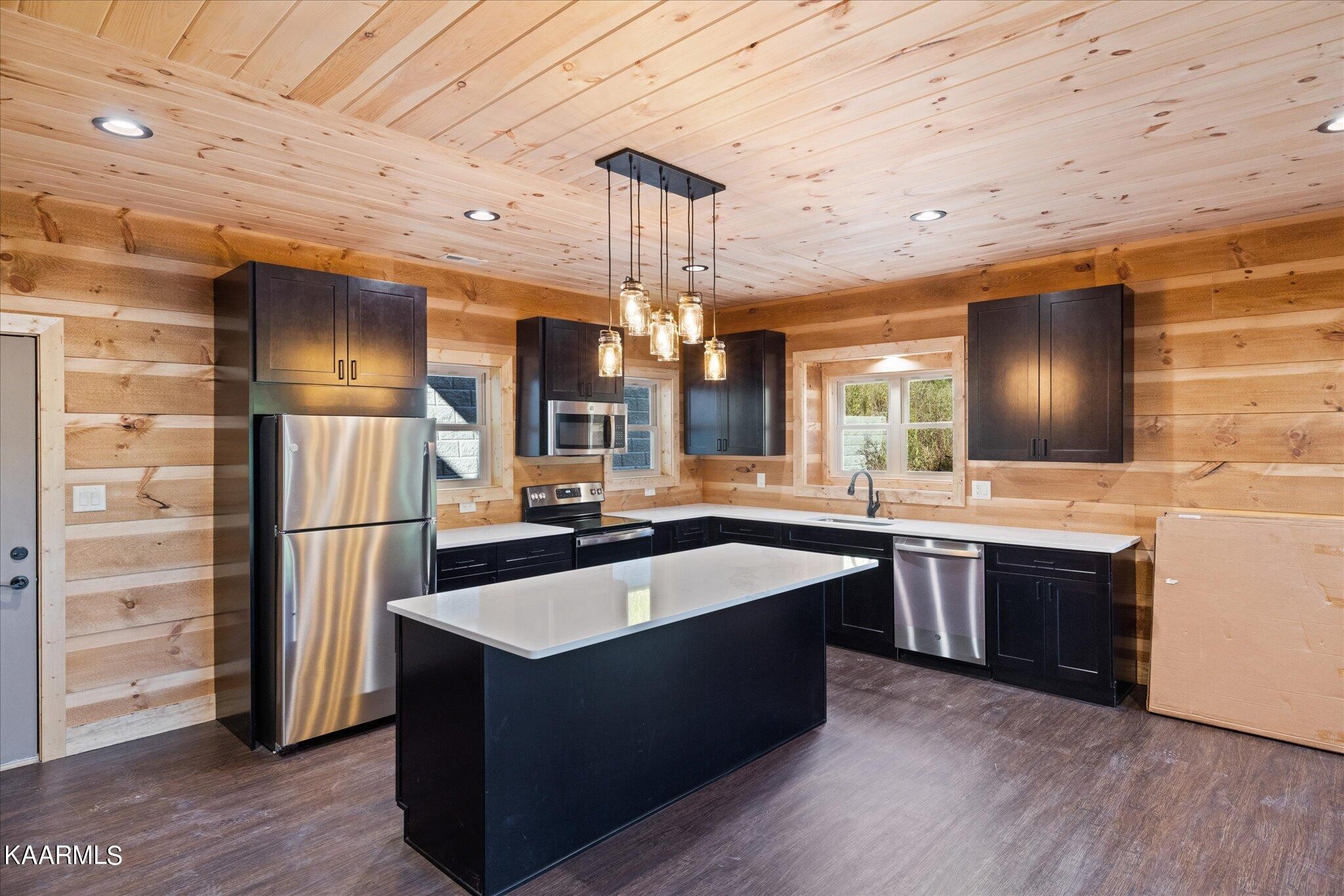 4228 Wears Valley Road, Unit 71 Sevierville, TN 37862 - Photo 8 of 28 a kitchen with kitchen island granite countertop a sink and refrigerator