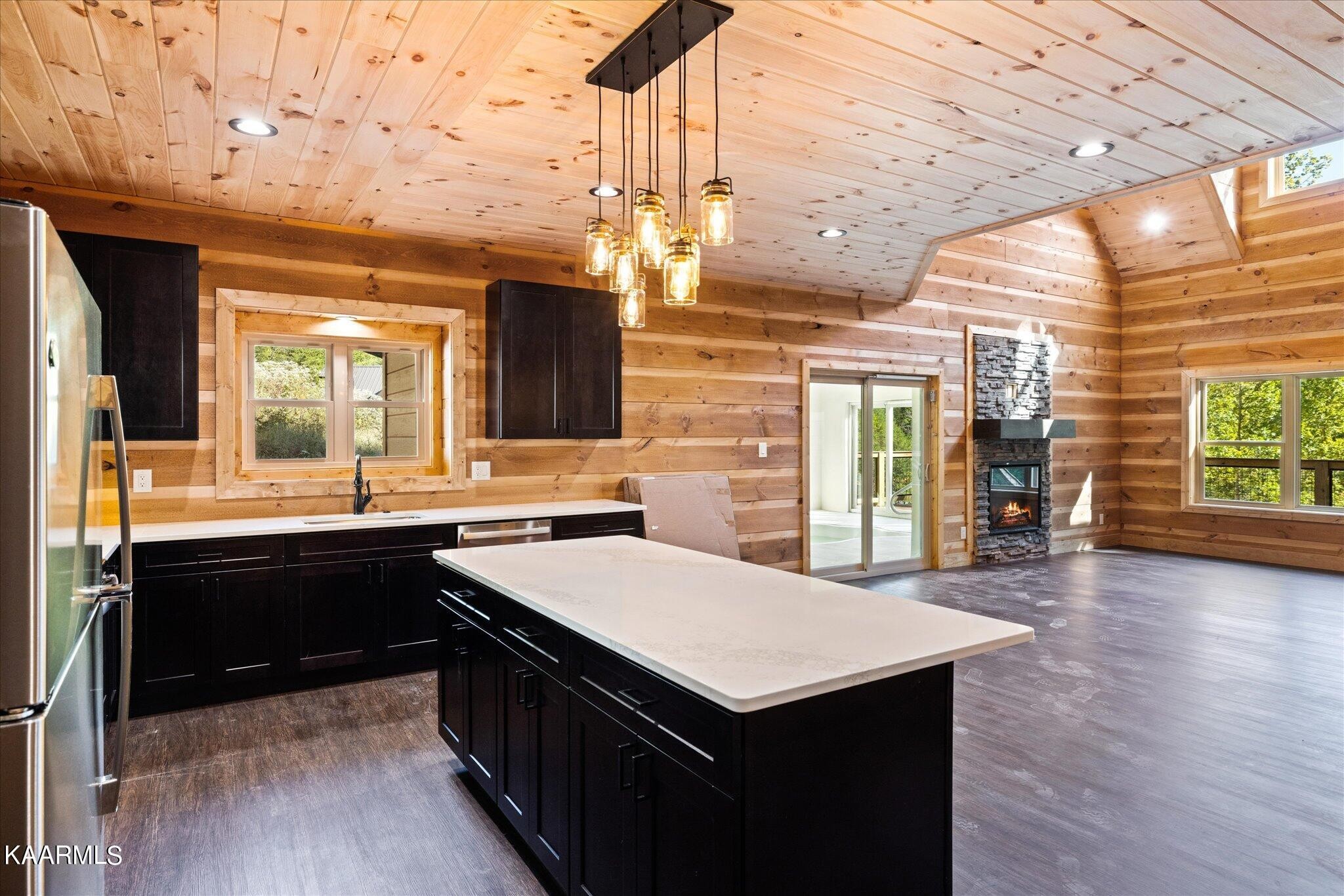 4228 Wears Valley Road, Unit 71 Sevierville, TN 37862 - Photo 9 of 28 a kitchen with a stove a sink dishwasher a kitchen island with wooden cabinets and floor