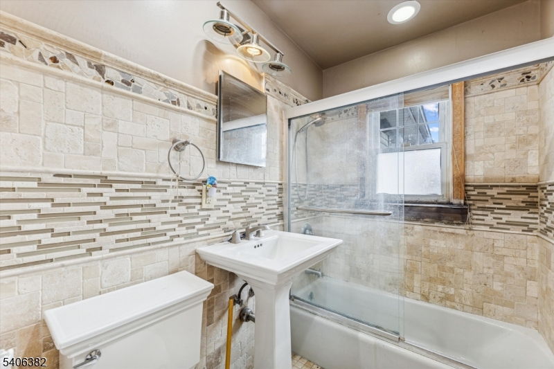 39-27 Taylor Road Fair Lawn, NJ 07410 - Photo 12 of 27 a bathroom with a sink a toilet and bathtub