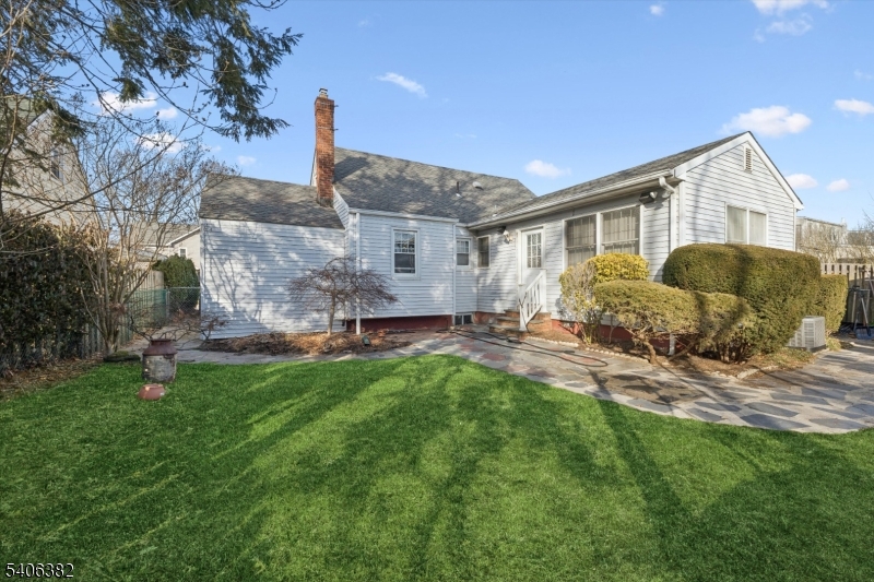 39-27 Taylor Road Fair Lawn, NJ 07410 - Photo 20 of 27 a front view of a house with a garden