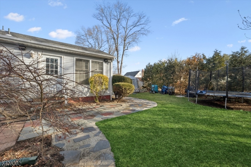 39-27 Taylor Road Fair Lawn, NJ 07410 - Photo 21 of 27 a view of a yard in front of a house with a large tree