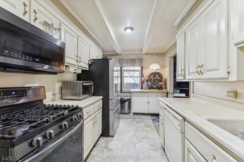 39-27 Taylor Road Fair Lawn, NJ 07410 - Photo 7 of 27 a kitchen with a stove a sink and a microwave