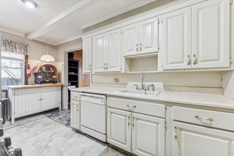 39-27 Taylor Road Fair Lawn, NJ 07410 - Photo 8 of 27 a kitchen with white cabinets and sink