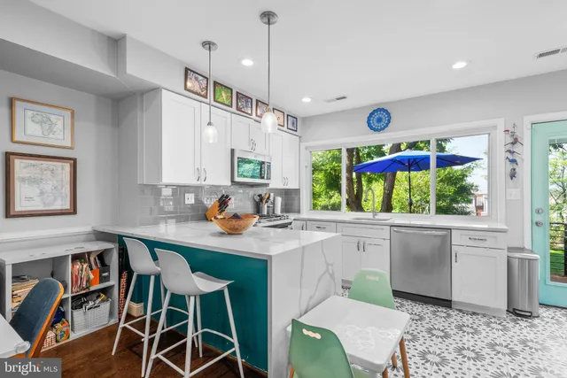 a kitchen with stainless steel appliances kitchen island granite countertop a sink and cabinets