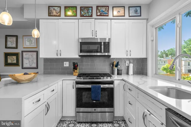 a kitchen with stainless steel appliances granite countertop a stove a sink and a granite counter tops