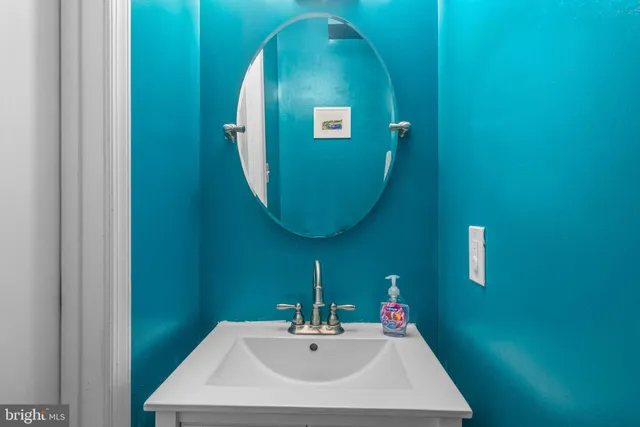 a bathroom with a sink and mirror