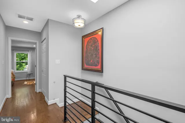 a view of hallway with wooden floor