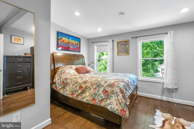 a bed sitting in a bedroom next to a window