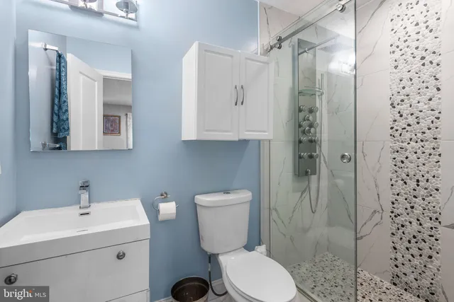 a bathroom with a toilet sink and shower