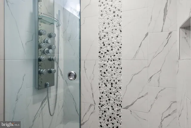 a bathroom with a shower and a glass door