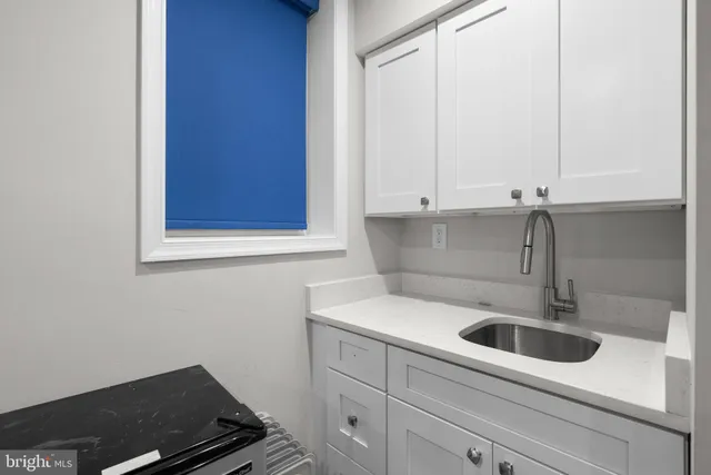 a blue room with furniture and a wooden floor