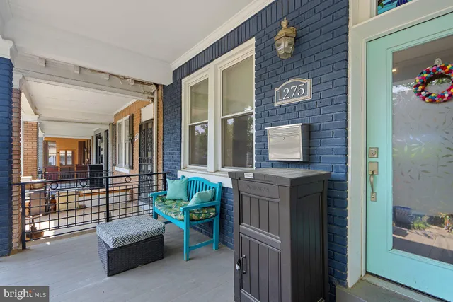 front view of a brick house with a large windows