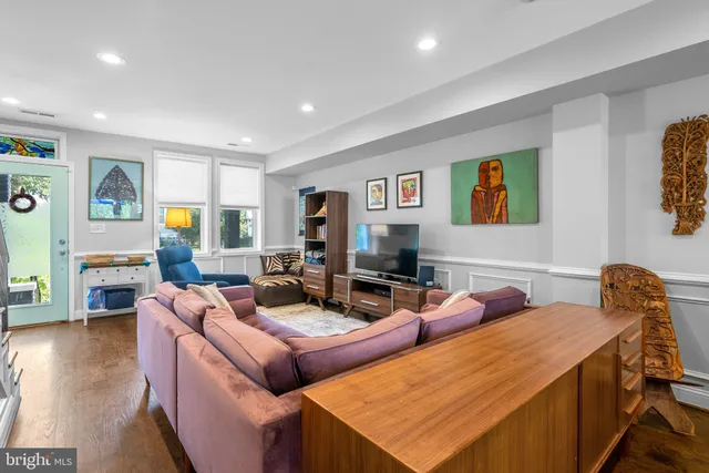 a living room with furniture and wooden floor