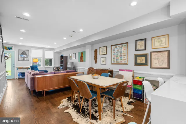 a living room with dining room and wooden floor