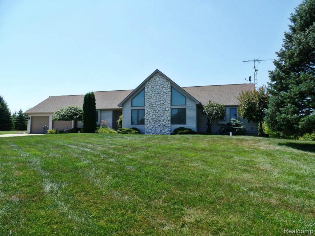 A hilltop setting welcomes you home to 6340 Vassar Rd., Grand Blanc, MI 48439. 