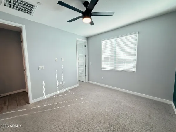 a spacious bathroom with a shower sink and mirror