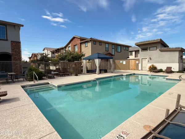 a front view of a house with swimming pool having outdoor seating