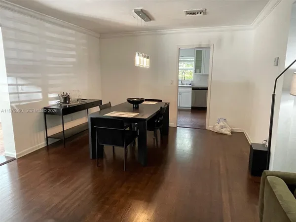 a dining room with furniture and wooden floor