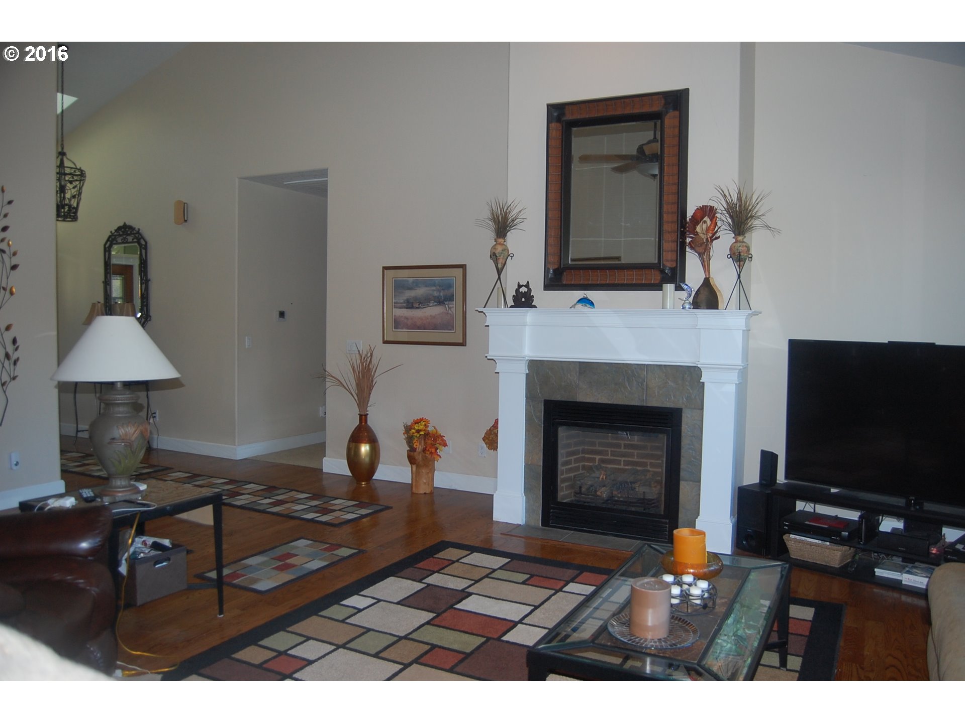 8325 Buffalo Lane Grand Ronde, OR 97347 - Photo 5 of 24 a living room with furniture a fireplace and a flat screen tv