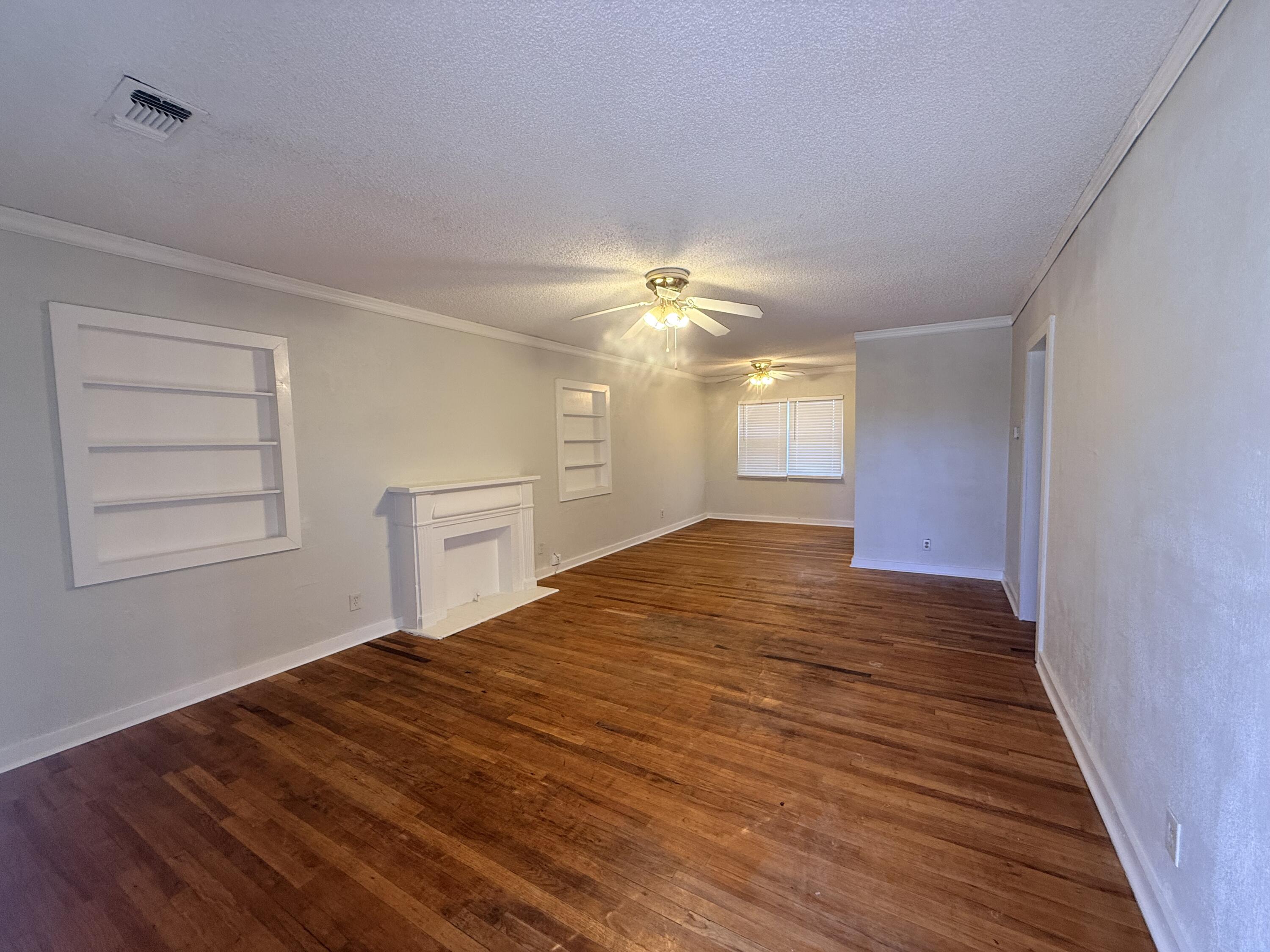 3418 25th Street Lubbock, TX 79410 - Photo 2 of 14 a big room with wooden floor and windows